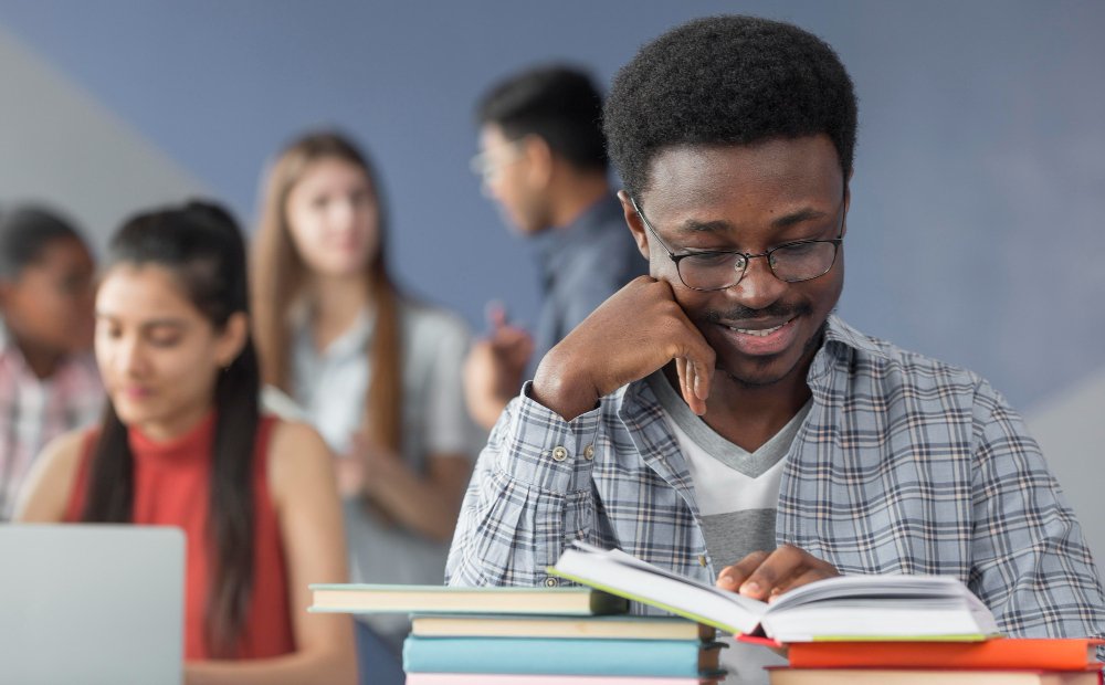 a diverse group of university students studying together in a modern library, natural light streaming through large windows, creating a collaborative and supportive atmosphere